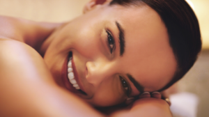 woman smiling after microneedling appointment at dr saba raja