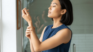 woman admiring her smooth skin after treatment at Dr Saba Raja